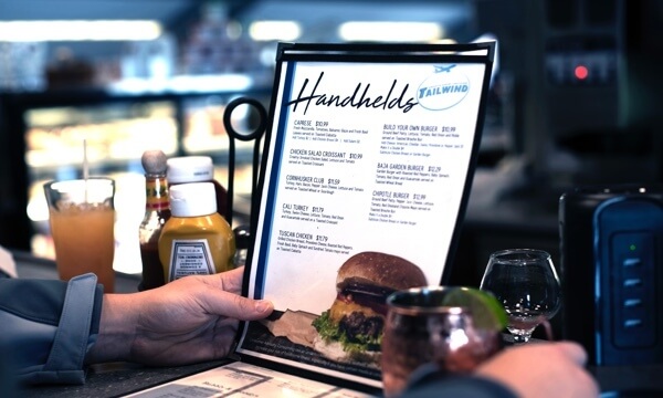 person holding a restaurant menu