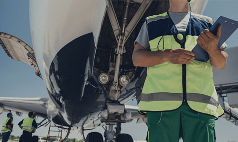 airport staff next to airplane